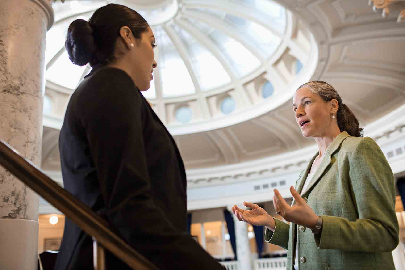 GettyImages-482146479 two public administrators having a conversation in a large building