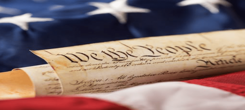 Screenshot 2023-09-18 at 4.23.00 PM the U.S. Constitution with an American flag in the background